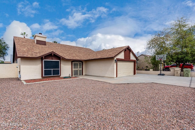 view of front of house featuring stucco siding, concrete driveway, an attached garage, a shingled roof, and a chimney