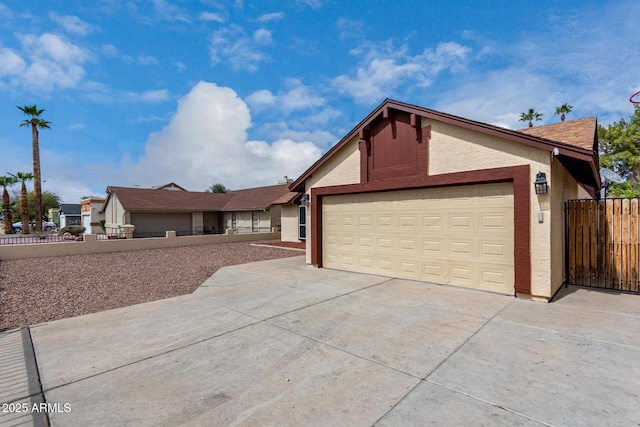 ranch-style home with stucco siding, concrete driveway, an attached garage, and fence