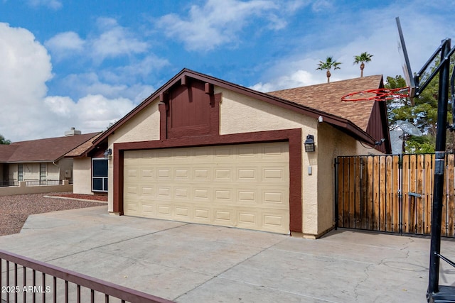 exterior space with fence, concrete driveway, and a gate