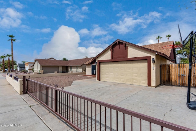 view of front of home featuring a gate, fence, driveway, stucco siding, and a garage