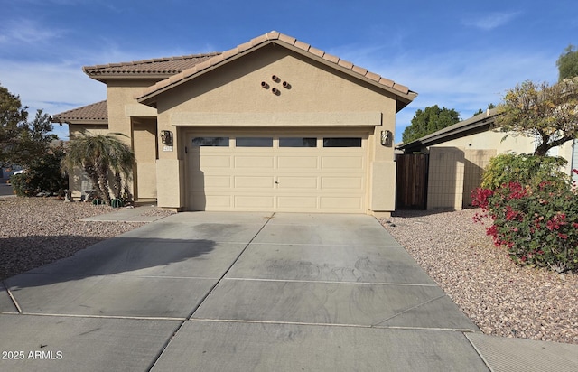 12558 W Jefferson St, Avondale, AZ 85323 - view of front of home with driveway, a tile roof, an attached garage, and stucco siding