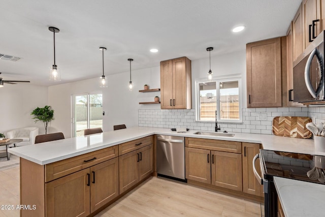 802 E Navajo Ave, Apache Junction, AZ 85119 - kitchen with stainless steel appliances, a peninsula, tasteful backsplash, open floor plan, and recessed lighting