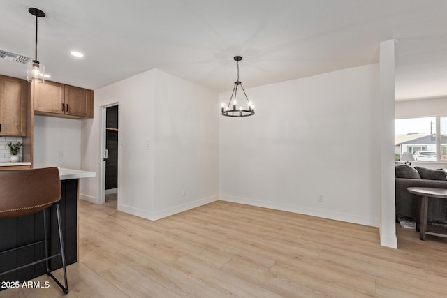 802 E Navajo Ave, Apache Junction, AZ 85119 - kitchen featuring light wood-type flooring, light countertops, decorative light fixtures, backsplash, and recessed lighting