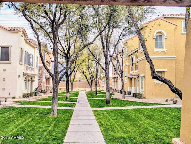 view of community featuring a residential view and a lawn