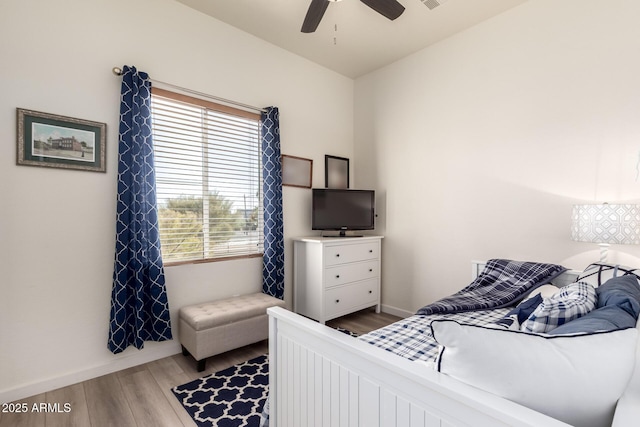 bedroom featuring visible vents, baseboards, wood finished floors, and a ceiling fan