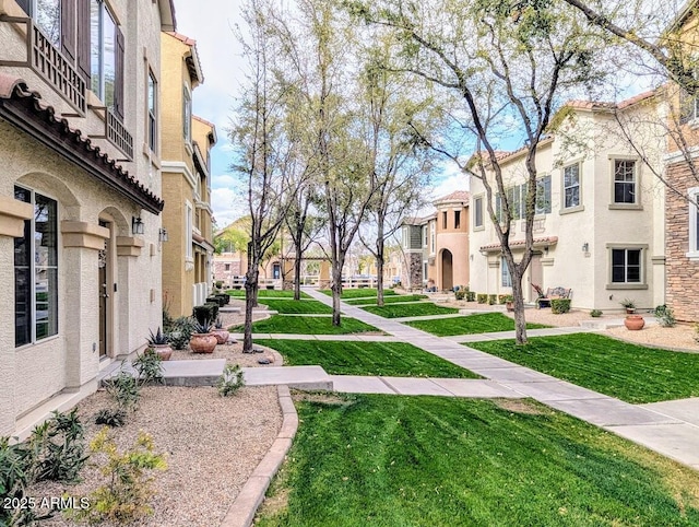 view of home's community featuring a residential view and a lawn