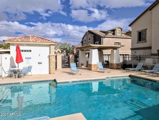 pool featuring a patio and fence