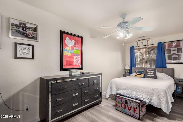 bedroom with visible vents, light wood-style flooring, and a ceiling fan