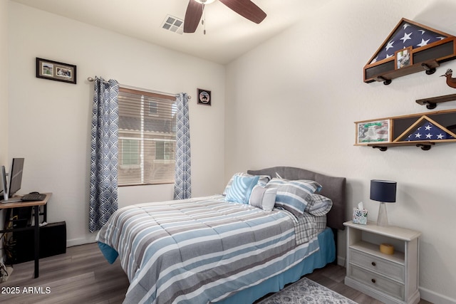 bedroom with visible vents, baseboards, and wood finished floors