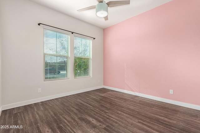 spare room featuring ceiling fan and dark hardwood / wood-style flooring