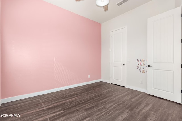 unfurnished bedroom featuring ceiling fan and dark hardwood / wood-style flooring