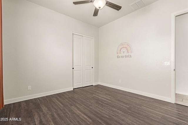 unfurnished room with ceiling fan and dark hardwood / wood-style flooring