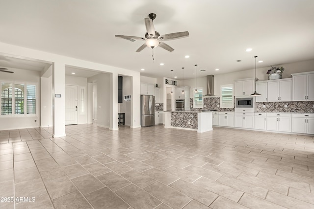 unfurnished living room featuring ceiling fan