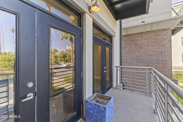 view of exterior entry featuring a balcony