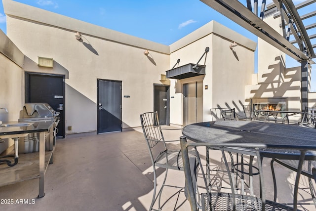 view of patio with area for grilling and exterior kitchen