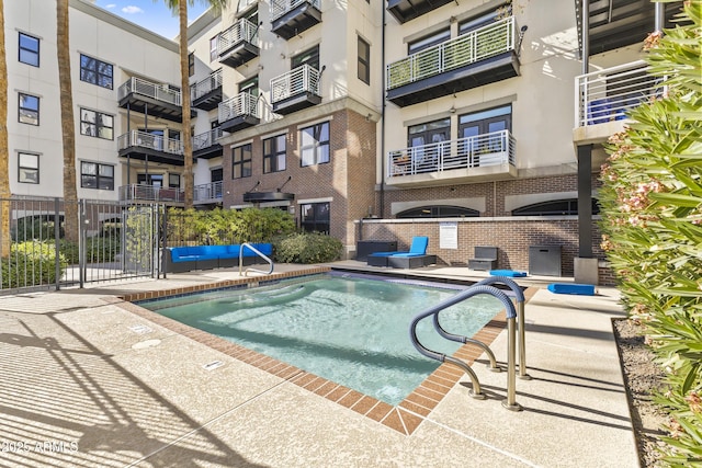 view of pool featuring a patio and an AC wall unit