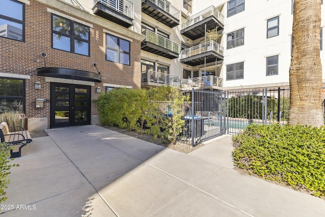 exterior space with a community pool and french doors