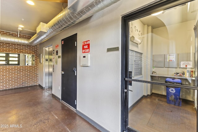 interior space with elevator, brick wall, and mail boxes