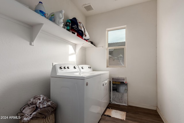 laundry area with washer and dryer and dark hardwood / wood-style flooring