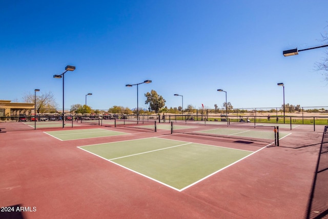 view of tennis court with basketball hoop