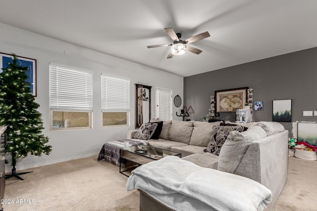 carpeted living room with ceiling fan