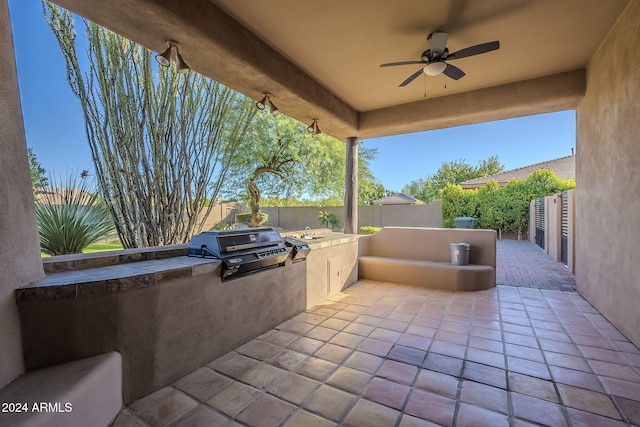 view of patio with ceiling fan, an outdoor kitchen, and area for grilling