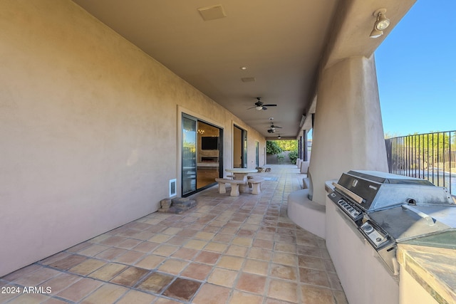 view of patio / terrace with ceiling fan and exterior kitchen