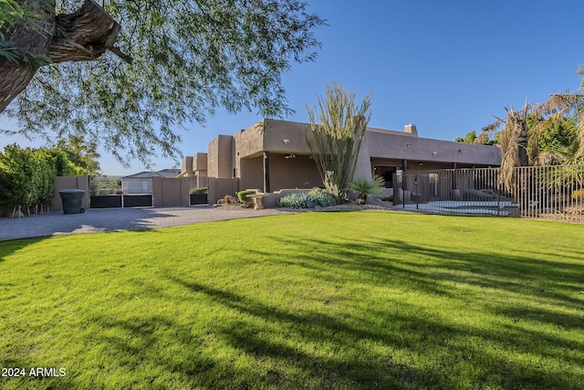 24005 N 45th Dr, Glendale, AZ 85310 - rear view of house with a gate and stucco siding