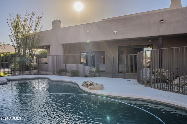 view of pool at dusk