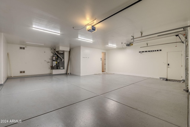 garage featuring water heater and a garage door opener