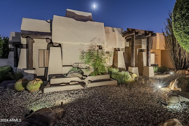 view of property exterior at night