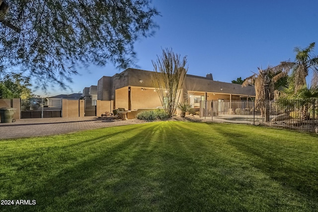 rear view of property featuring a lawn