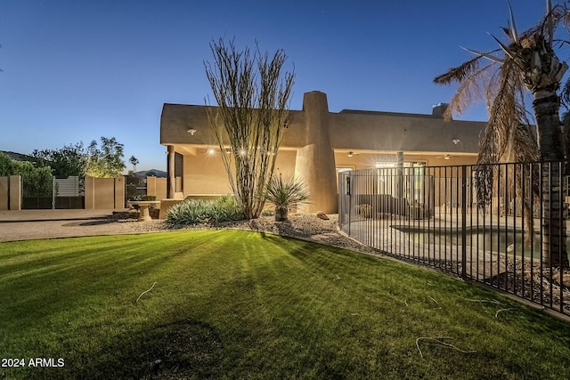 rear view of house featuring a yard