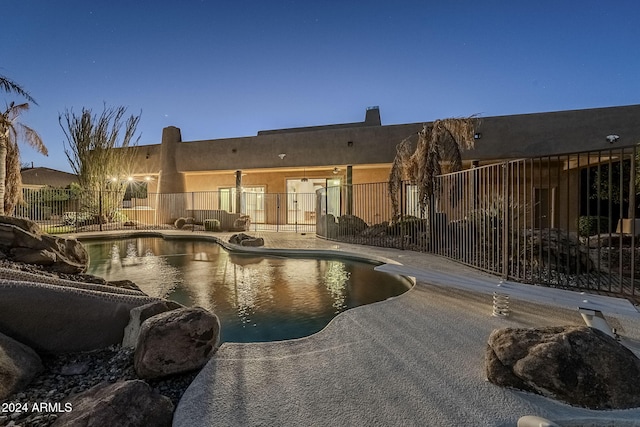 view of pool at dusk