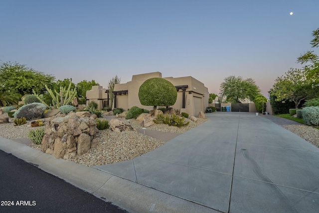 24005 N 45th Dr, Glendale, AZ 85310 - adobe home featuring stucco siding, driveway, and an attached garage