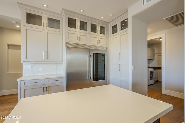 kitchen featuring appliances with stainless steel finishes, light hardwood / wood-style floors, and white cabinets