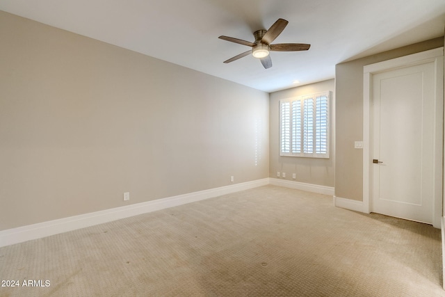 unfurnished bedroom featuring light carpet and ceiling fan