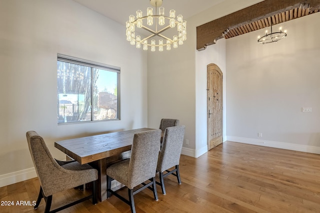 dining room featuring hardwood / wood-style floors and a chandelier