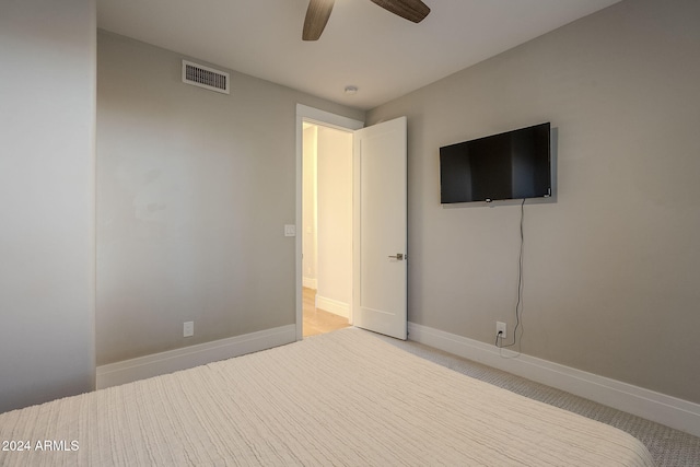 unfurnished bedroom featuring ceiling fan and light colored carpet