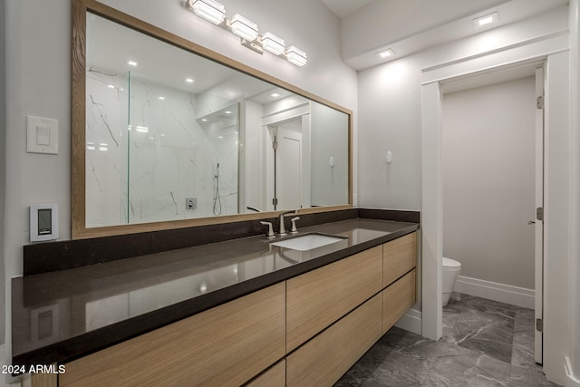 bathroom with walk in shower, vanity, and toilet