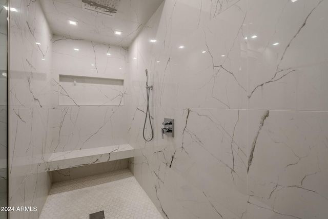 bathroom with a tile shower