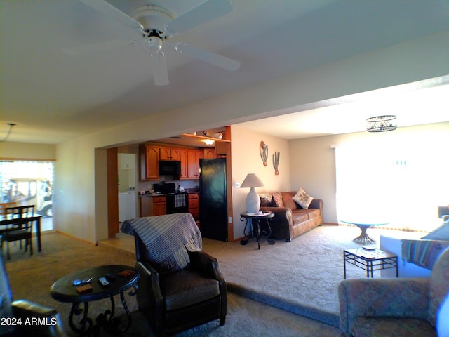 carpeted living room with ceiling fan