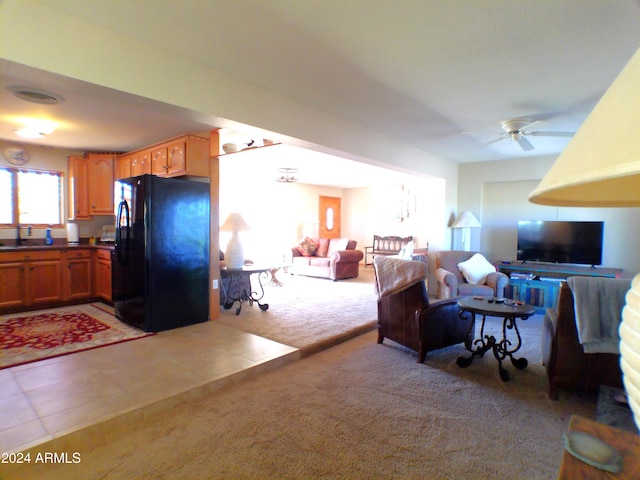 carpeted living room featuring ceiling fan