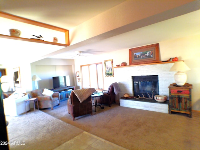 carpeted living room featuring ceiling fan and a brick fireplace