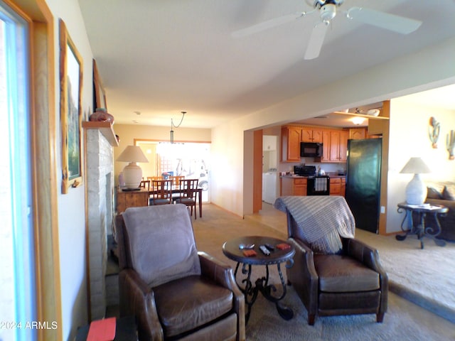 living room with light colored carpet and ceiling fan