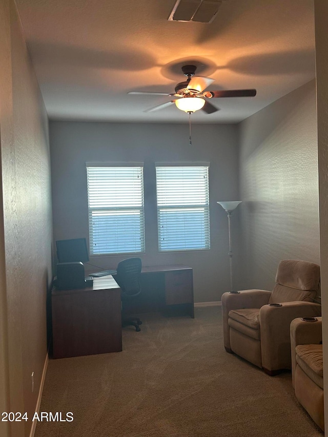 carpeted office space with ceiling fan