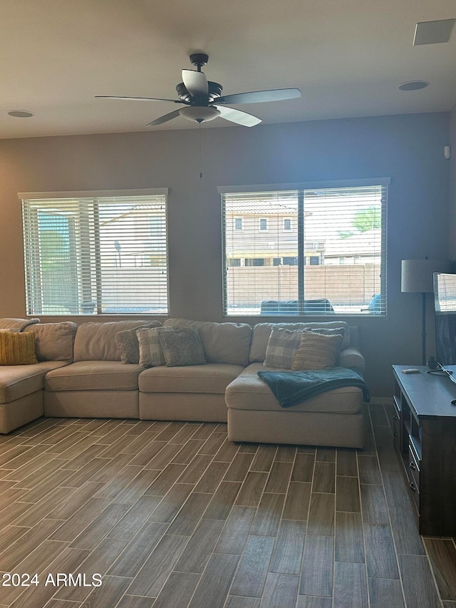 living room with ceiling fan and dark hardwood / wood-style flooring