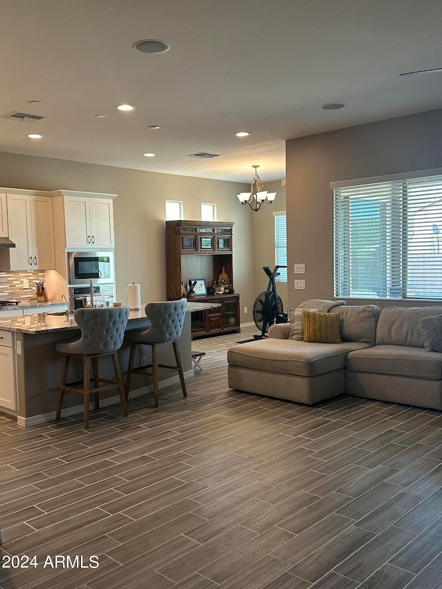 living room featuring dark hardwood / wood-style flooring and a notable chandelier