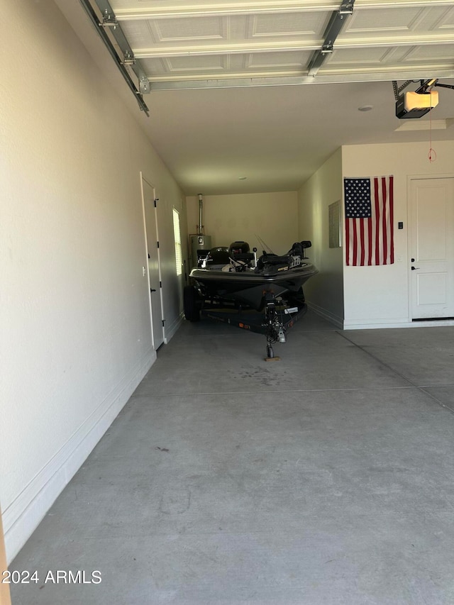 garage with water heater and a garage door opener