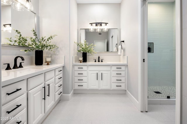 bathroom with an enclosed shower, vanity, and tile patterned flooring